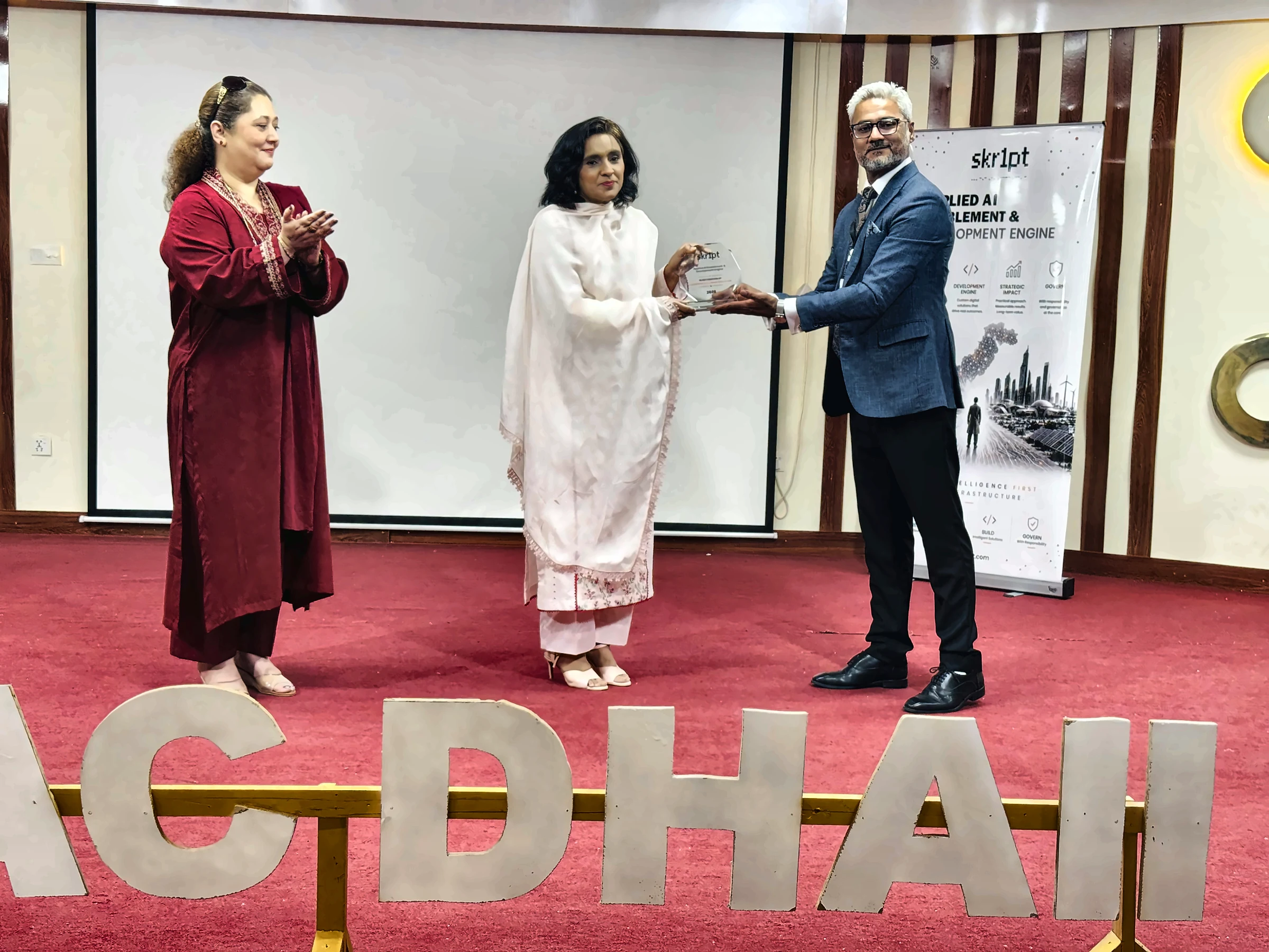 APSAC DHA II principal receiving a shield from the skr1pt team