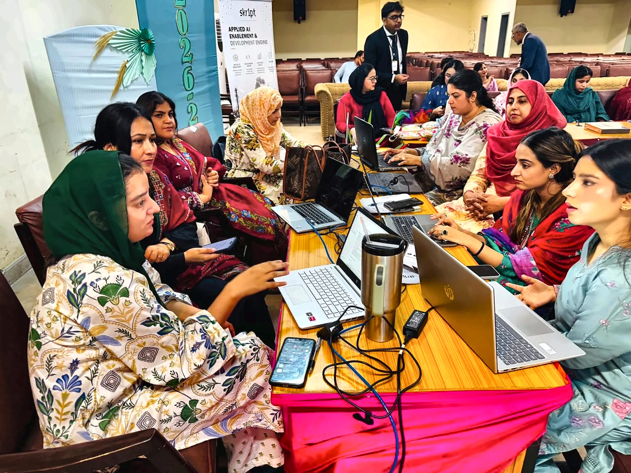 Educators collaborating on AI tasks during the training session